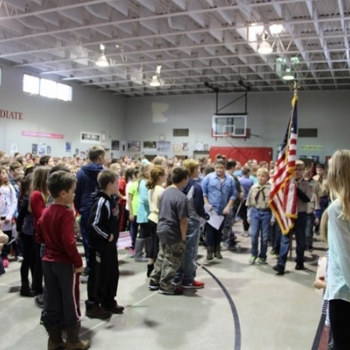 Local Boy Scouts present the colors and lead the audience in the Pledge of Allegiance